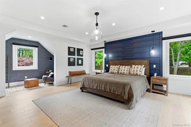 a bedroom with a bed a couch and dresser