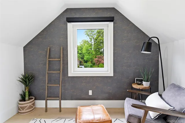 a living room with a couch and a potted plant