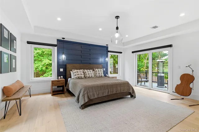 a bedroom with a bed and large windows