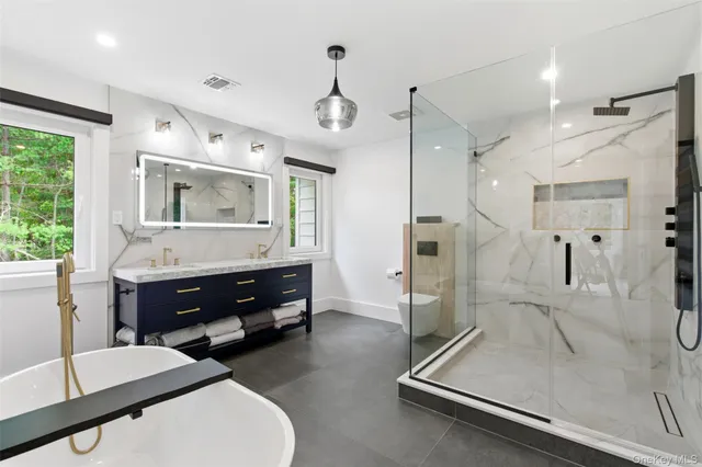 a living room with furniture and a large mirror