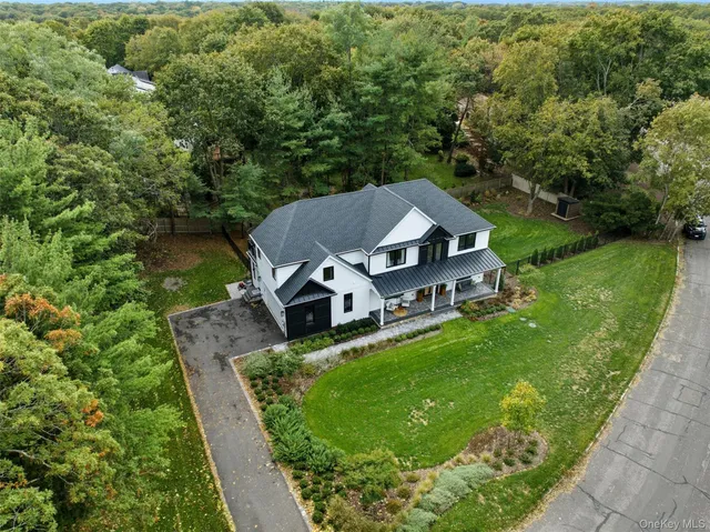 an aerial view of a house with swimming pool garden and patio
