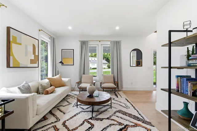 a living room with furniture and a book shelf