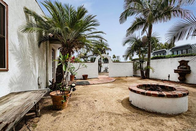 a view of a backyard with water fountain and a potted plant