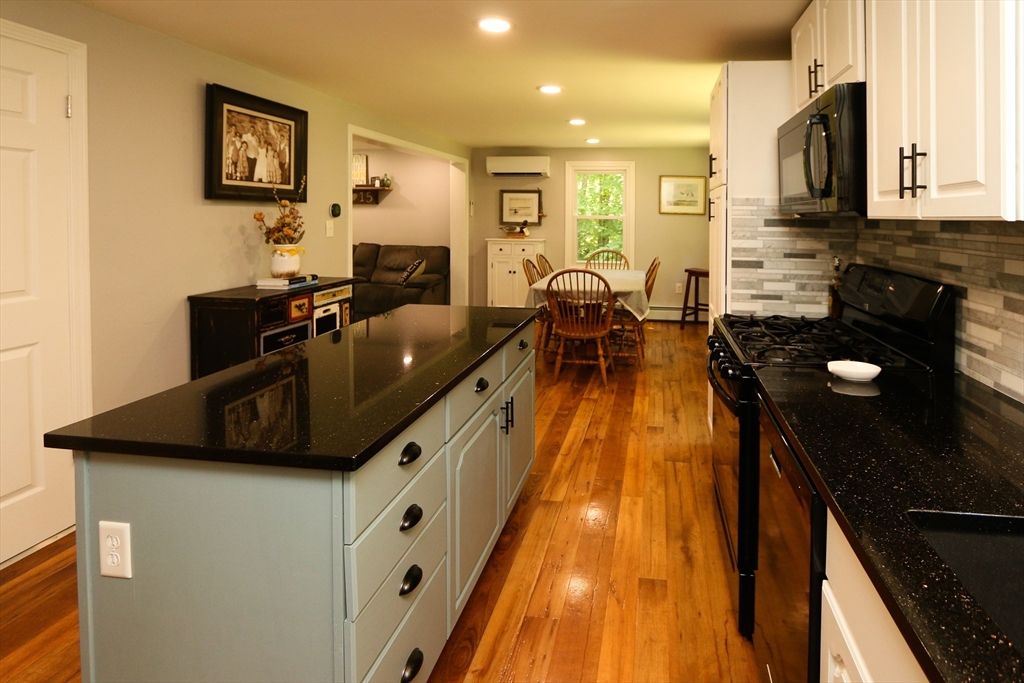 1 Battis Road Merrimac, MA 01860 - Photo 12 of 37 a kitchen with stainless steel appliances granite countertop a sink a stove top oven a chimney and a center island