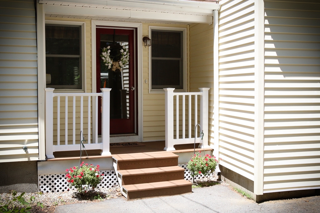 1 Battis Road Merrimac, MA 01860 - Photo 8 of 37 a front view of a house with a garden
