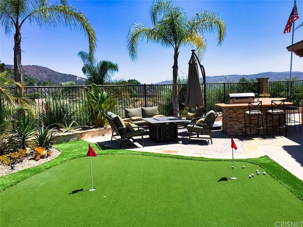 4274 Shawnee Street Moorpark, CA 93021 - Photo 41 of 45 a view of a backyard with a patio table and chairs