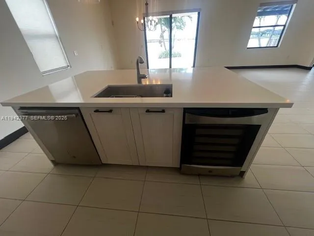 a kitchen with a sink cabinets and a window