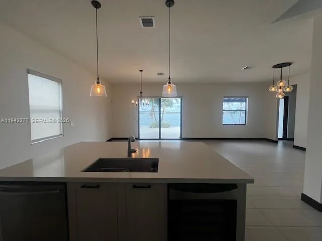 a view of a workspace with furniture and window