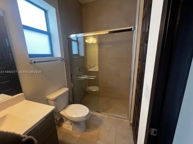 a white toilet sitting next to a bathroom sink