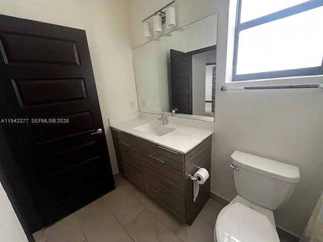 a bathroom with a sink toilet and mirror