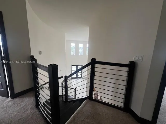 a view of a hallway with stairs