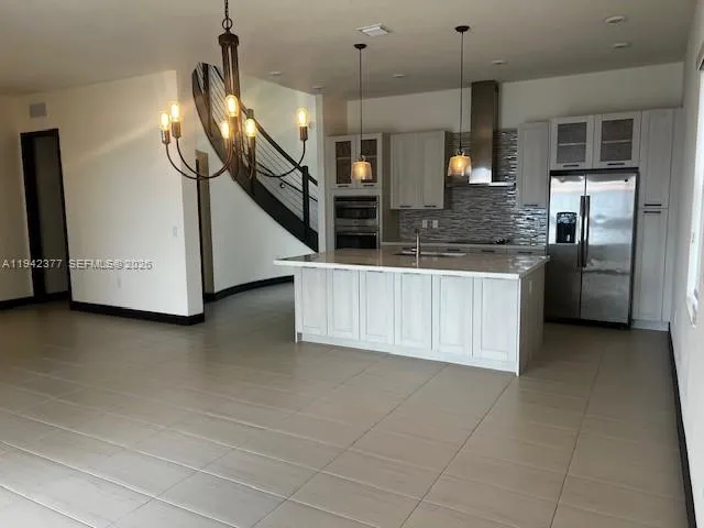 a kitchen with stainless steel appliances a kitchen island wooden cabinets and granite counter tops