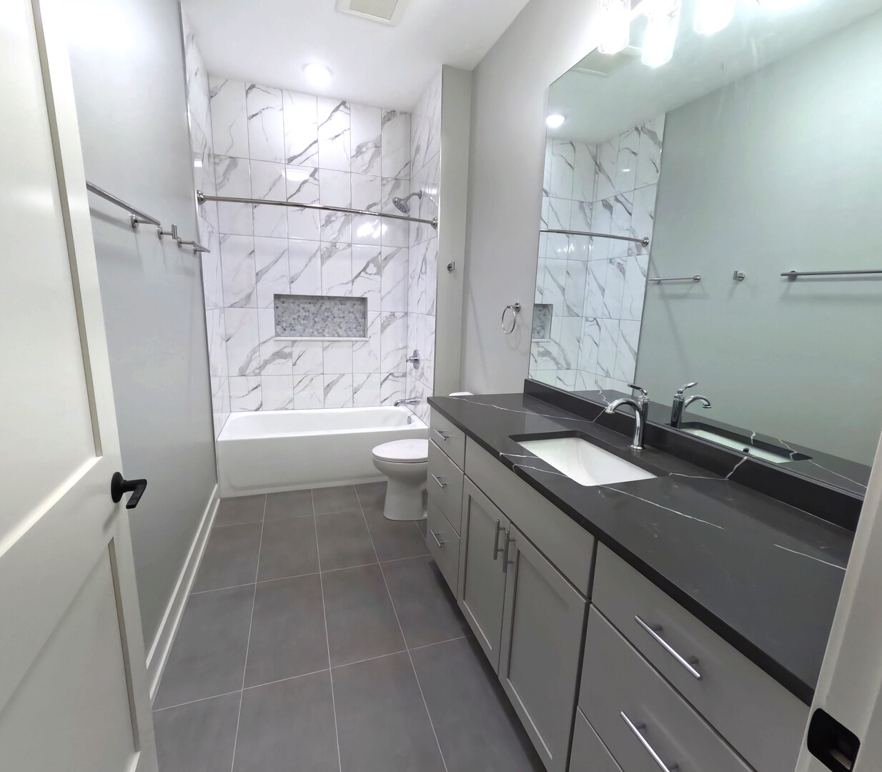 2100 West 18th Place, Unit 301 Chicago, IL 60608 - Photo 8 of 13 a bathroom with a granite countertop sink a toilet a mirror and shower