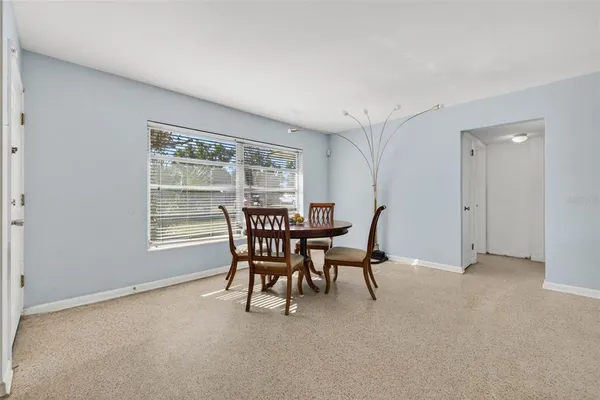 a view of a dining room with furniture and a window