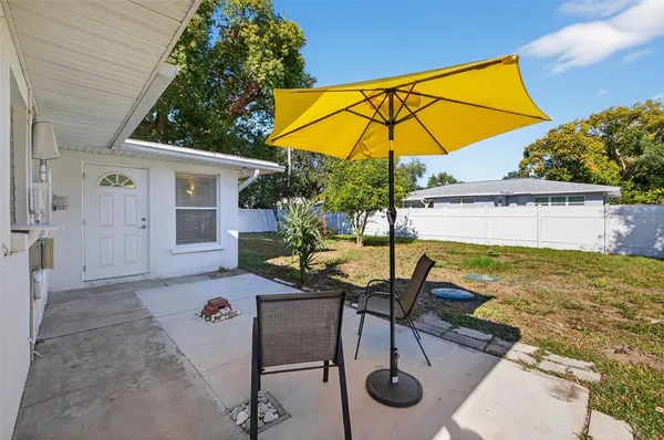 a view of a house with pool and chairs