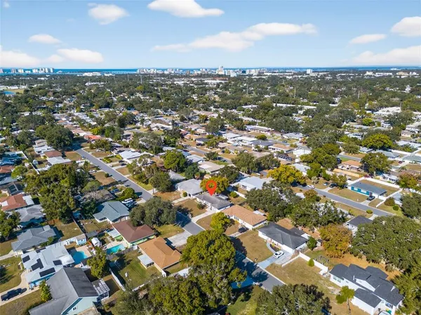 an aerial view of residential houses with city view