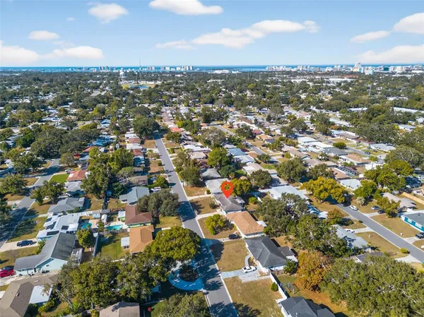 an aerial view of residential houses with city view