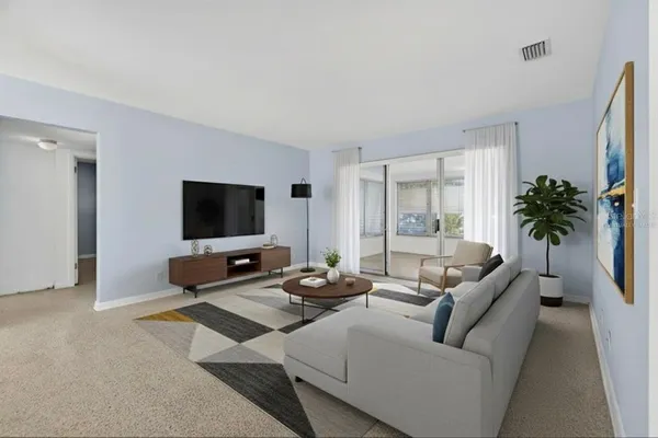a living room with furniture and a flat screen tv