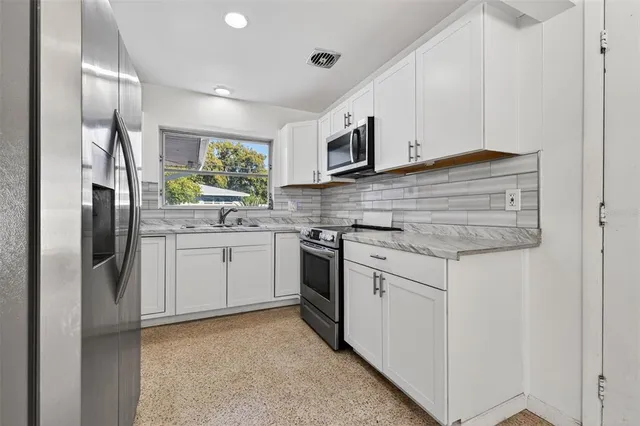 a living room with furniture and a glass door