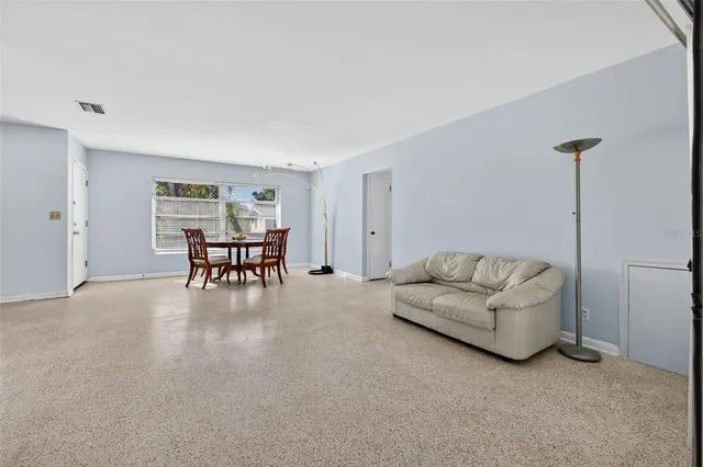 a dining room with furniture and window