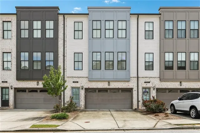 a front view of a building with a yard