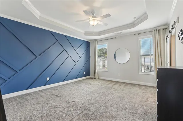 a view of a livingroom with wooden floor and a ceiling fan