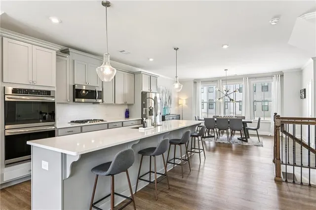 a large kitchen with cabinets table and chairs