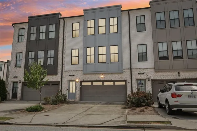 a front view of a building with potted plants