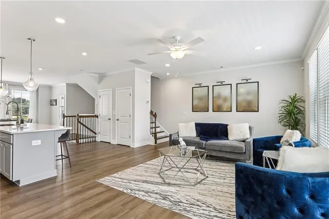 a living room with furniture and kitchen view