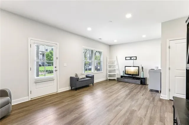a view of a livingroom with furniture wooden floor and window