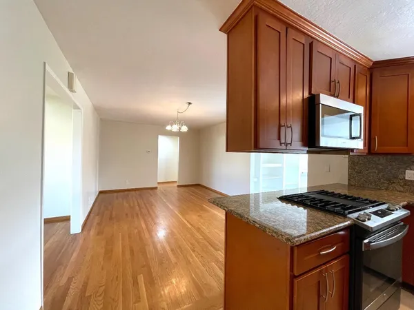 a kitchen with granite countertop cabinets and black appliances