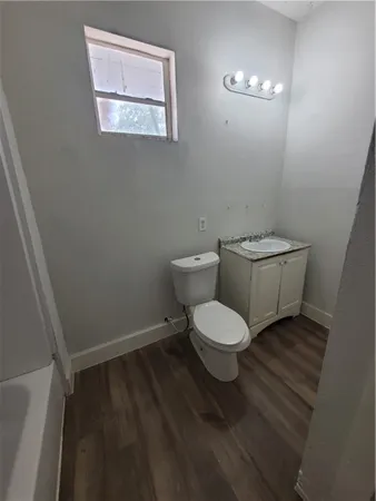 a bathroom with a toilet and a mirror