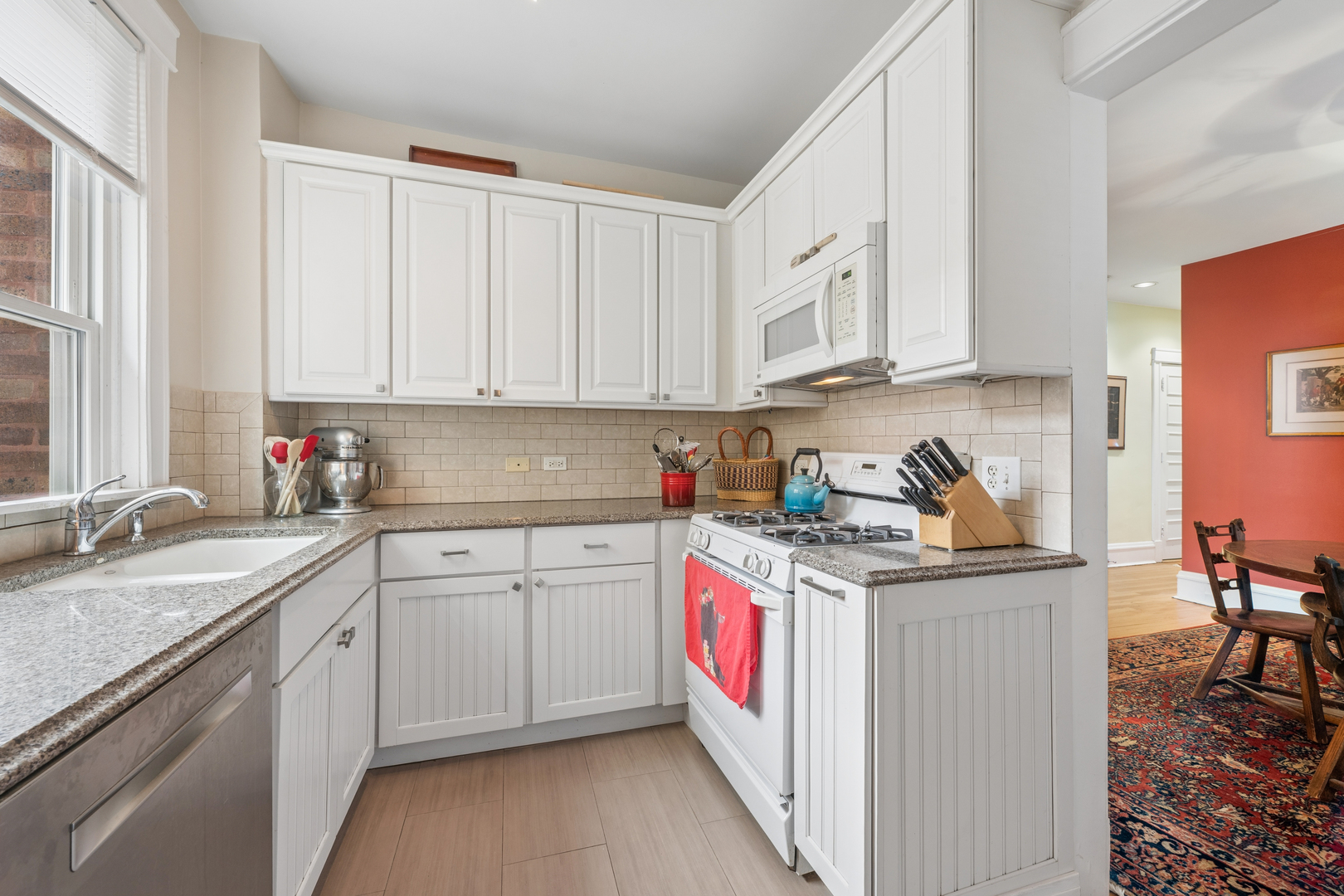 508 Lee Street, Unit 2E Evanston, IL 60202 - Photo 10 of 16 a kitchen with stainless steel appliances granite countertop a sink stove and cabinets