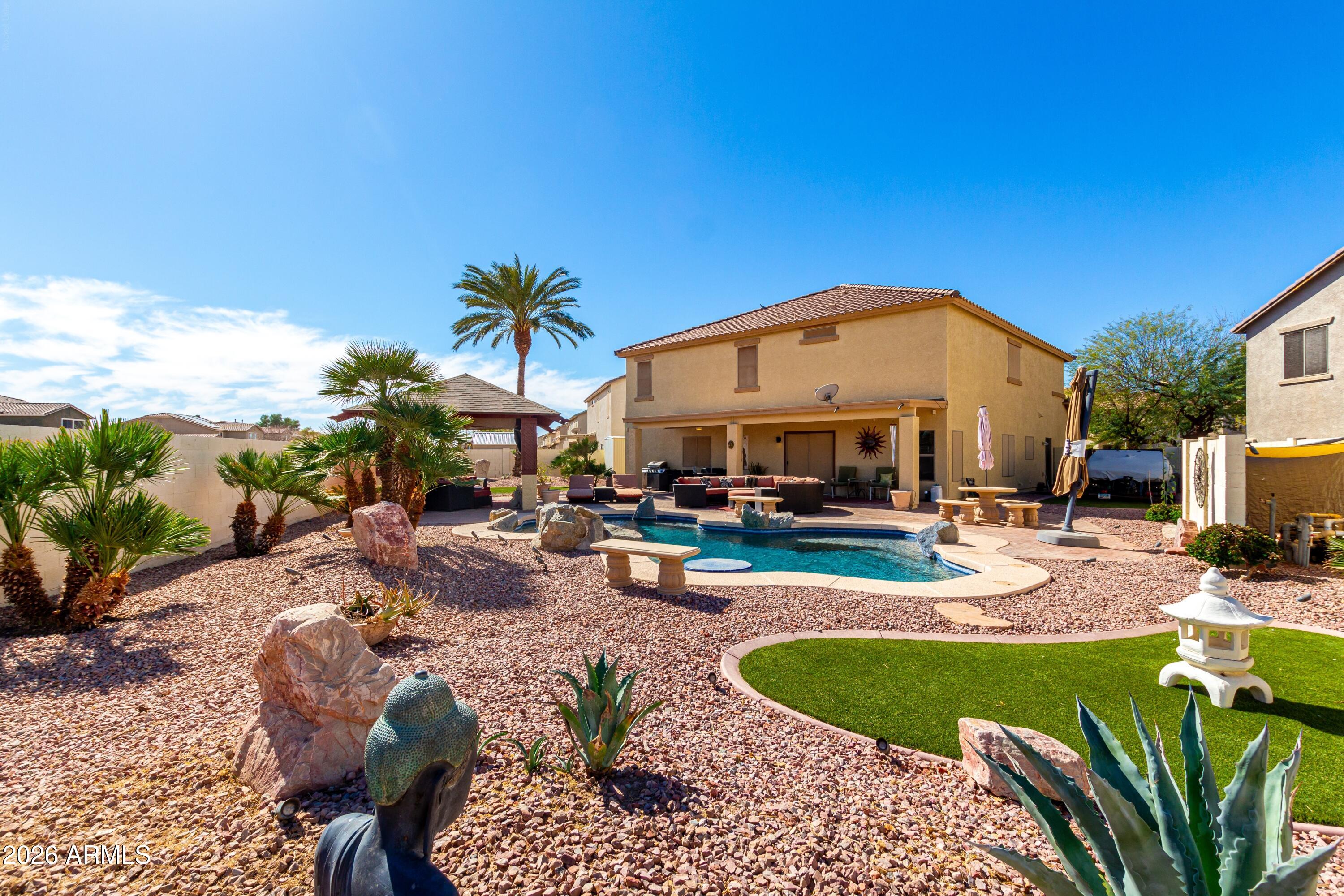19221 North Toya Street Maricopa, AZ 85138 - Photo 1 of 22 a view of a swimming pool with a patio