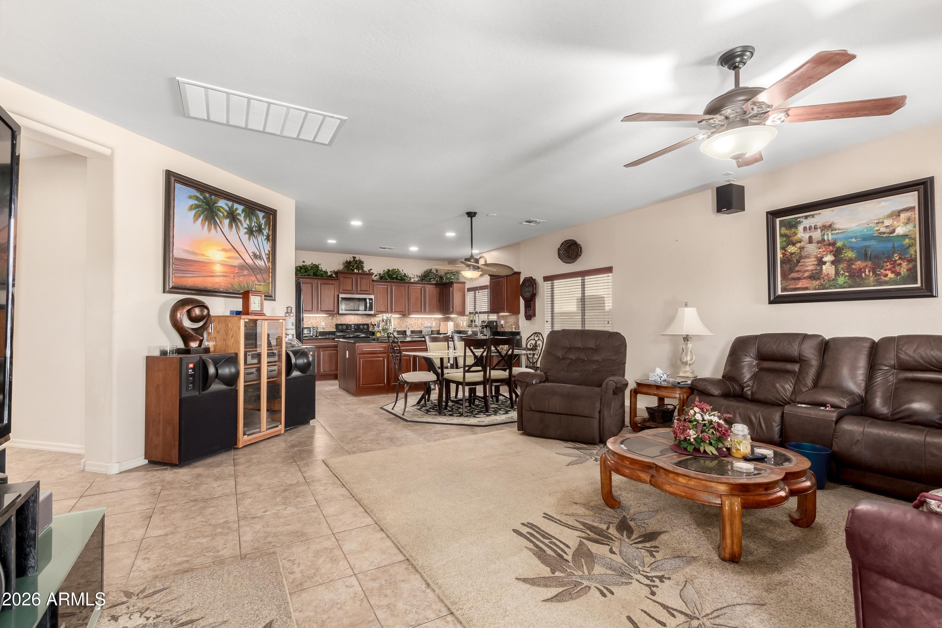 19221 North Toya Street Maricopa, AZ 85138 - Photo 11 of 22 a living room with furniture and a chandelier