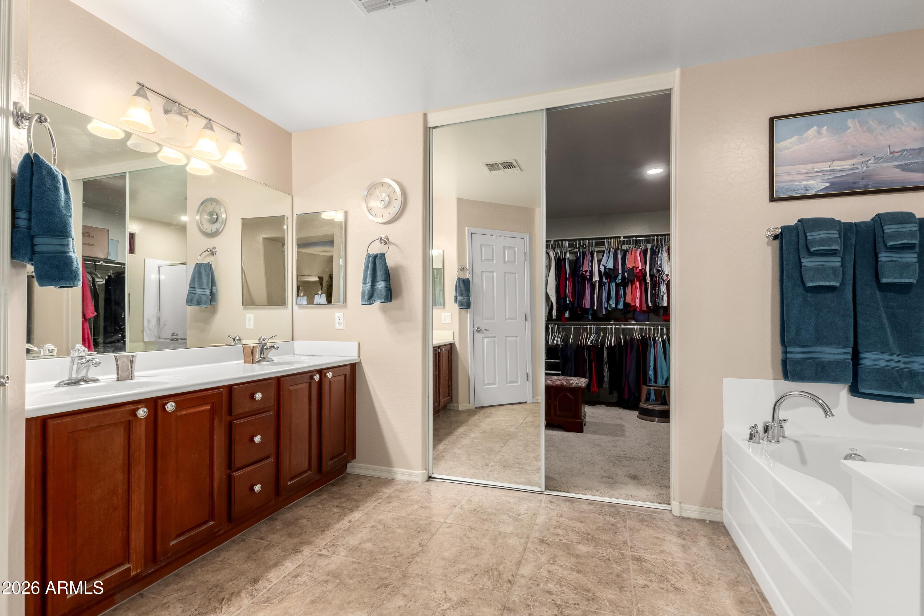 19221 North Toya Street Maricopa, AZ 85138 - Photo 17 of 22 a spacious bathroom with a tub sink and mirror