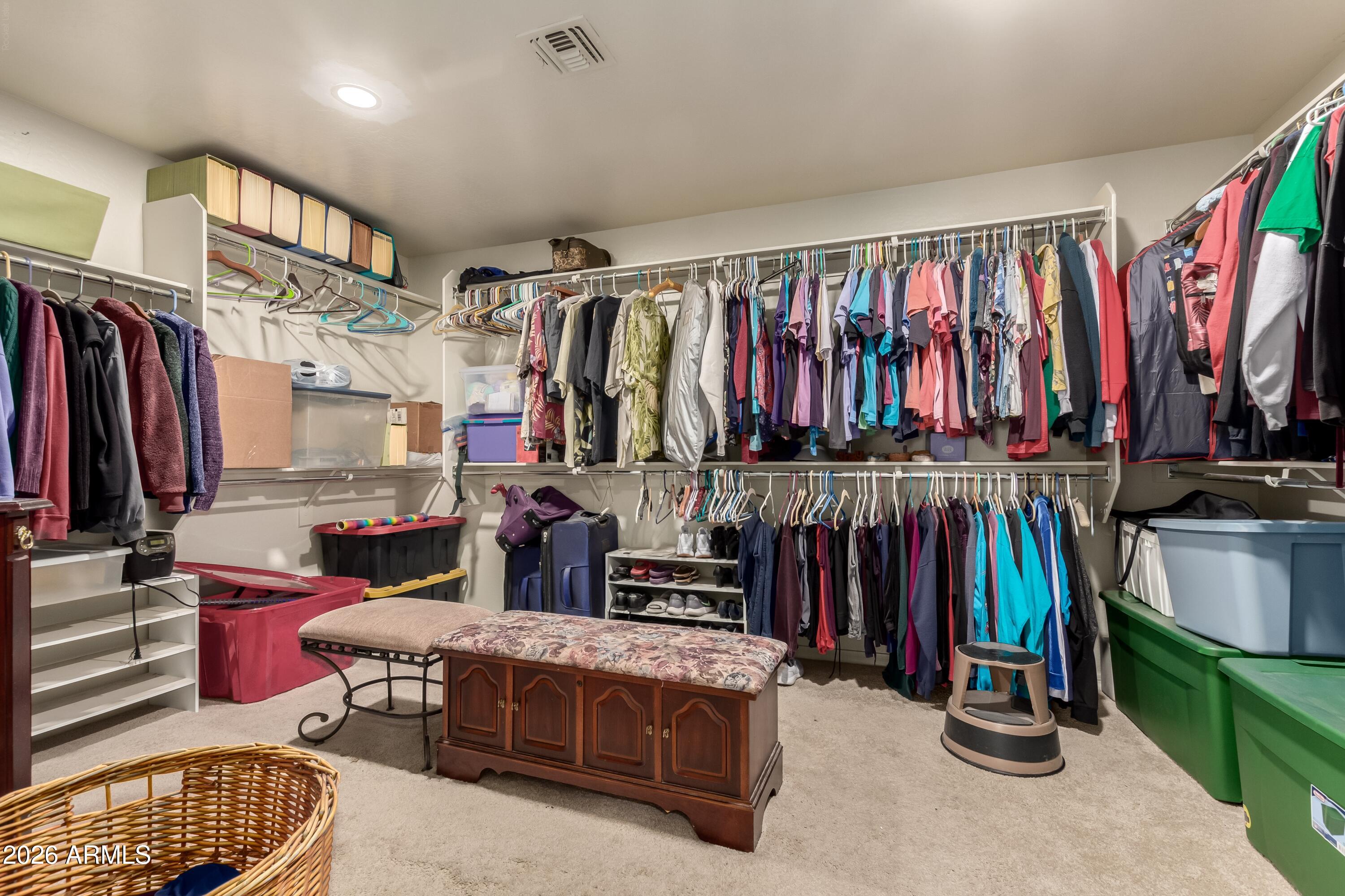 19221 North Toya Street Maricopa, AZ 85138 - Photo 19 of 22 a view of walk in closet with clothes and shoes