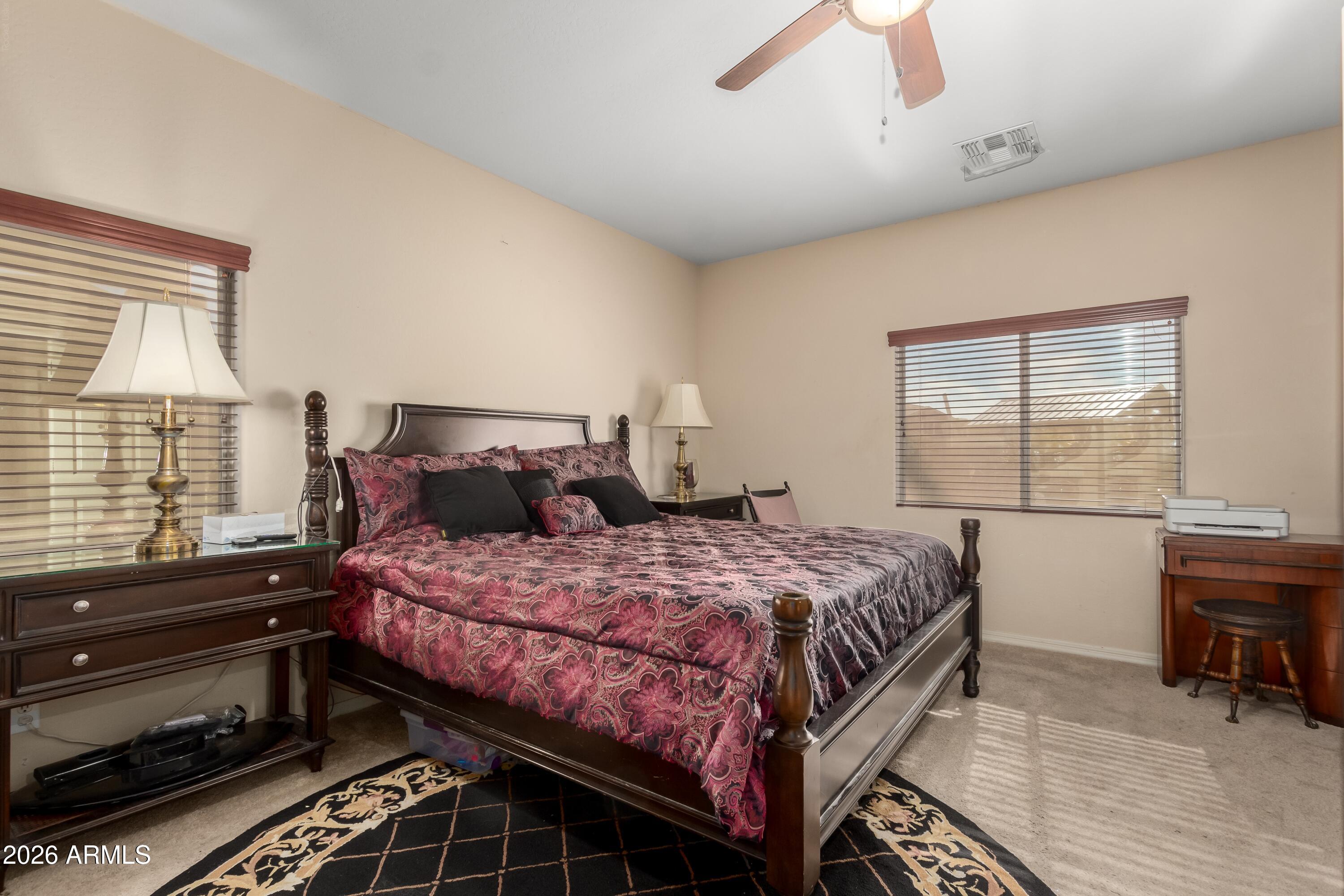 19221 North Toya Street Maricopa, AZ 85138 - Photo 20 of 22 a bedroom with a bed and wooden floor