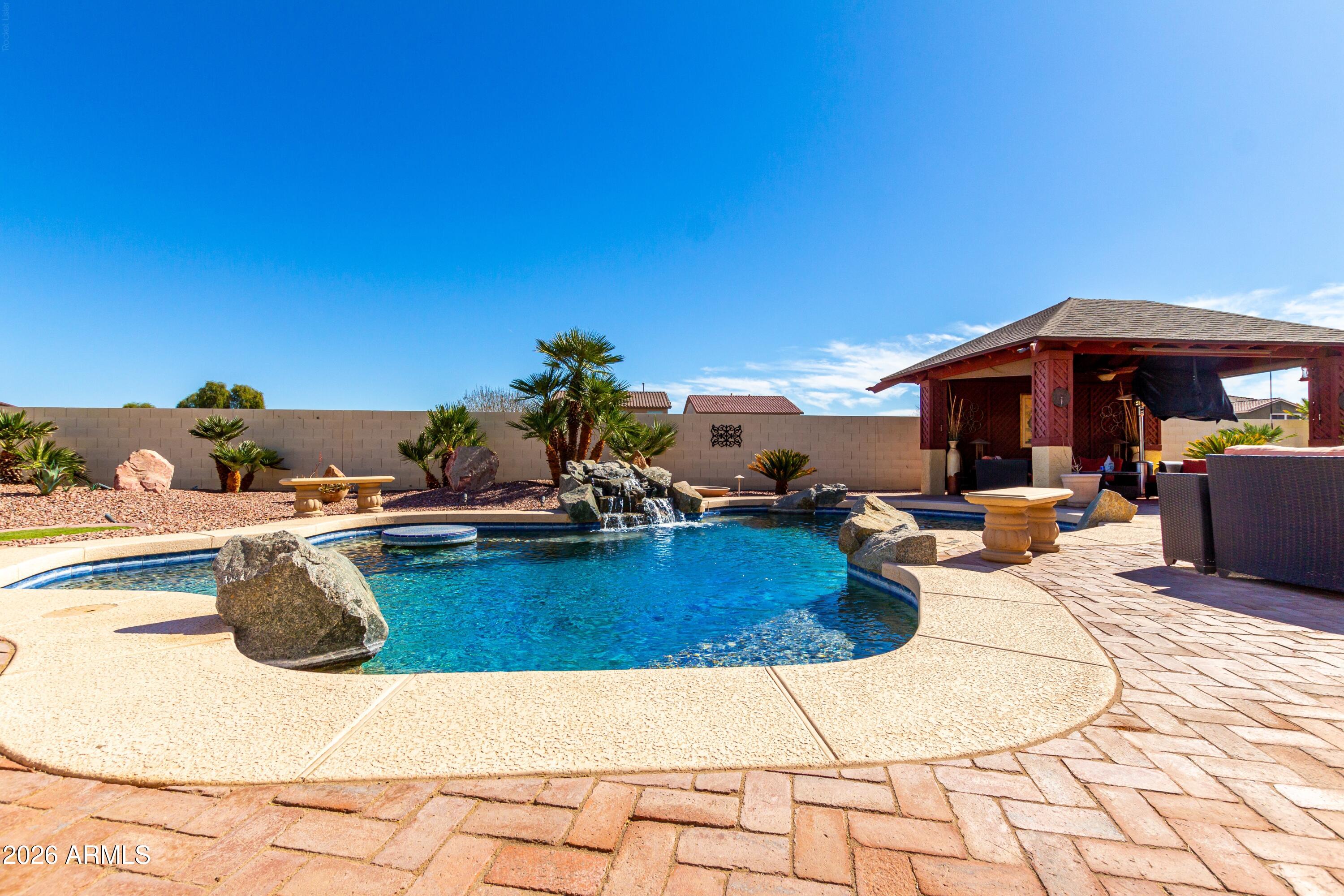 19221 North Toya Street Maricopa, AZ 85138 - Photo 6 of 22 a view of a swimming pool with outdoor seating