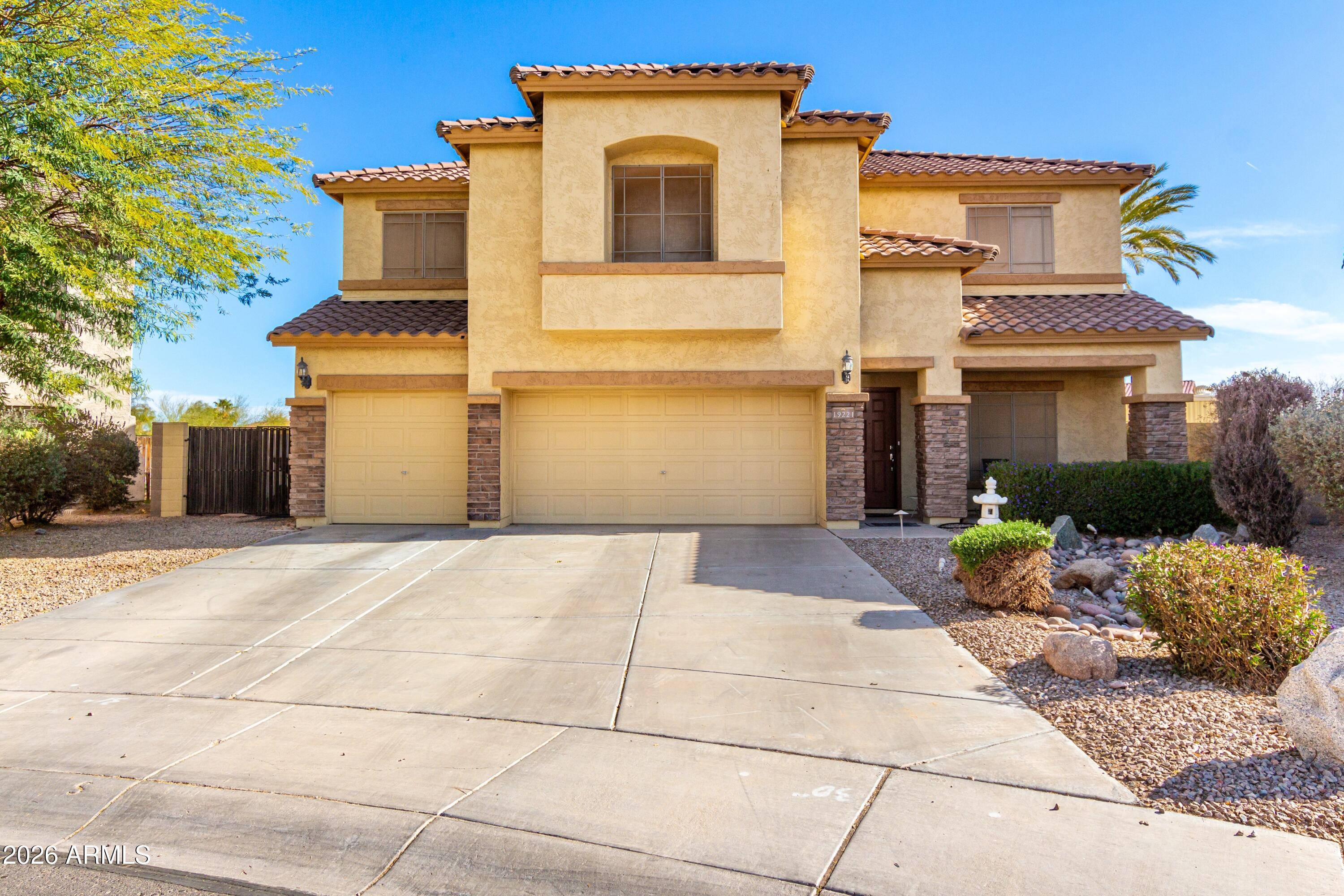 19221 North Toya Street Maricopa, AZ 85138 - Photo 10 of 22 a front view of a house with a yard