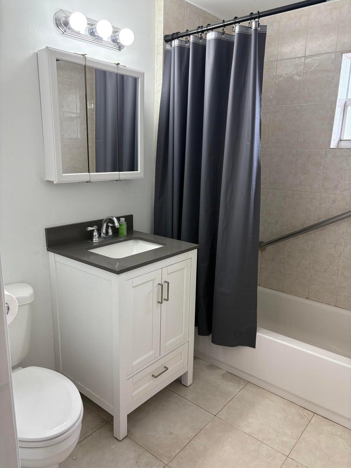 626 Minnesota Street Lantana, FL 33462 - Photo 12 of 15 a bathroom with a sink a toilet and shower