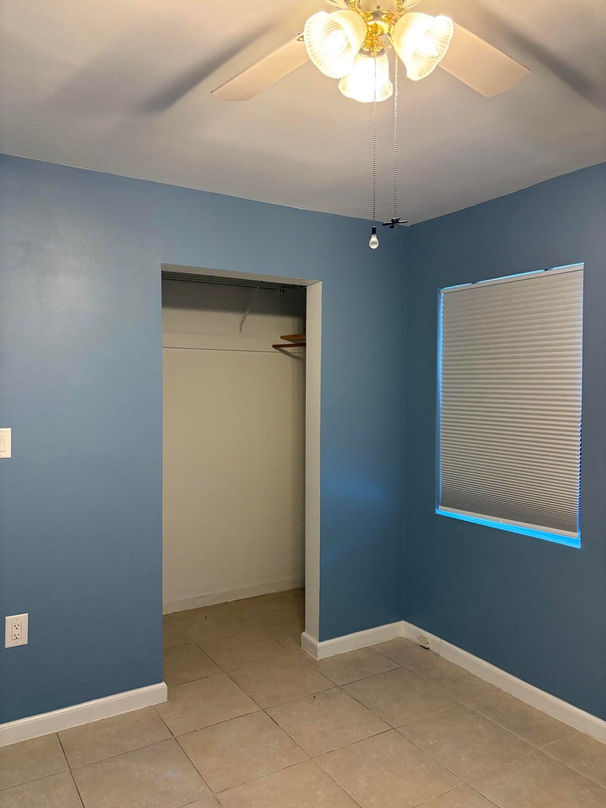 626 Minnesota Street Lantana, FL 33462 - Photo 6 of 15 an empty room with a chandelier fan