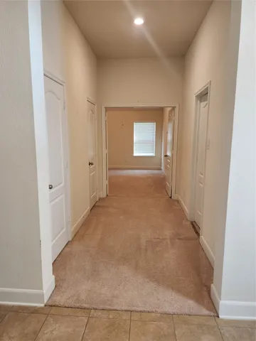 an empty room with windows and fireplace