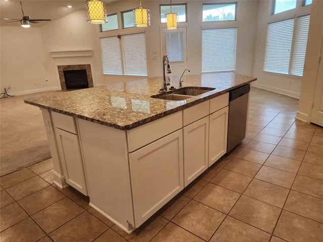 a bathroom with a granite countertop sink a mirror and a bathtub