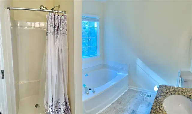 a bathroom with a tub and shower