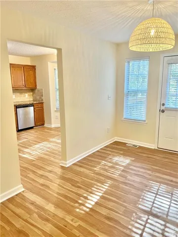 a view of a kitchen with wooden floor and a kitchen