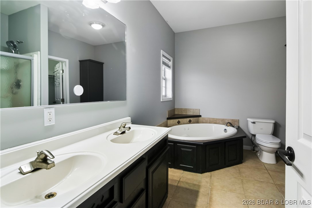 22 Navajo Road Four Seasons, MO 65049 - Photo 17 of 42 The primary bath has a nice jetted tub, standing s
