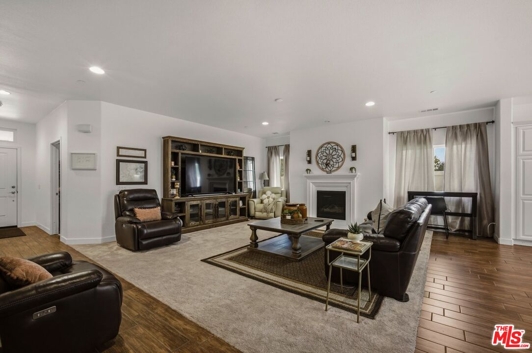 3065 Gibson Street Riverside, CA 92503 - Photo 11 of 15 a living room with furniture a fireplace and a flat screen tv