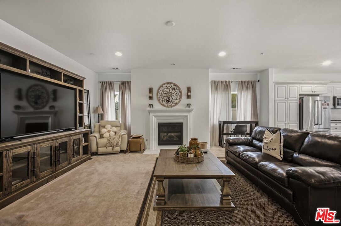 3065 Gibson Street Riverside, CA 92503 - Photo 12 of 15 a living room with furniture a flat screen tv and a fireplace