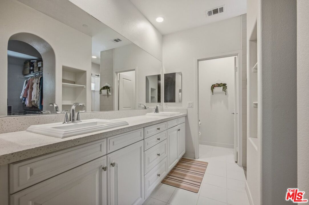 3065 Gibson Street Riverside, CA 92503 - Photo 5 of 15 a spacious bathroom with a double vanity sink and mirror